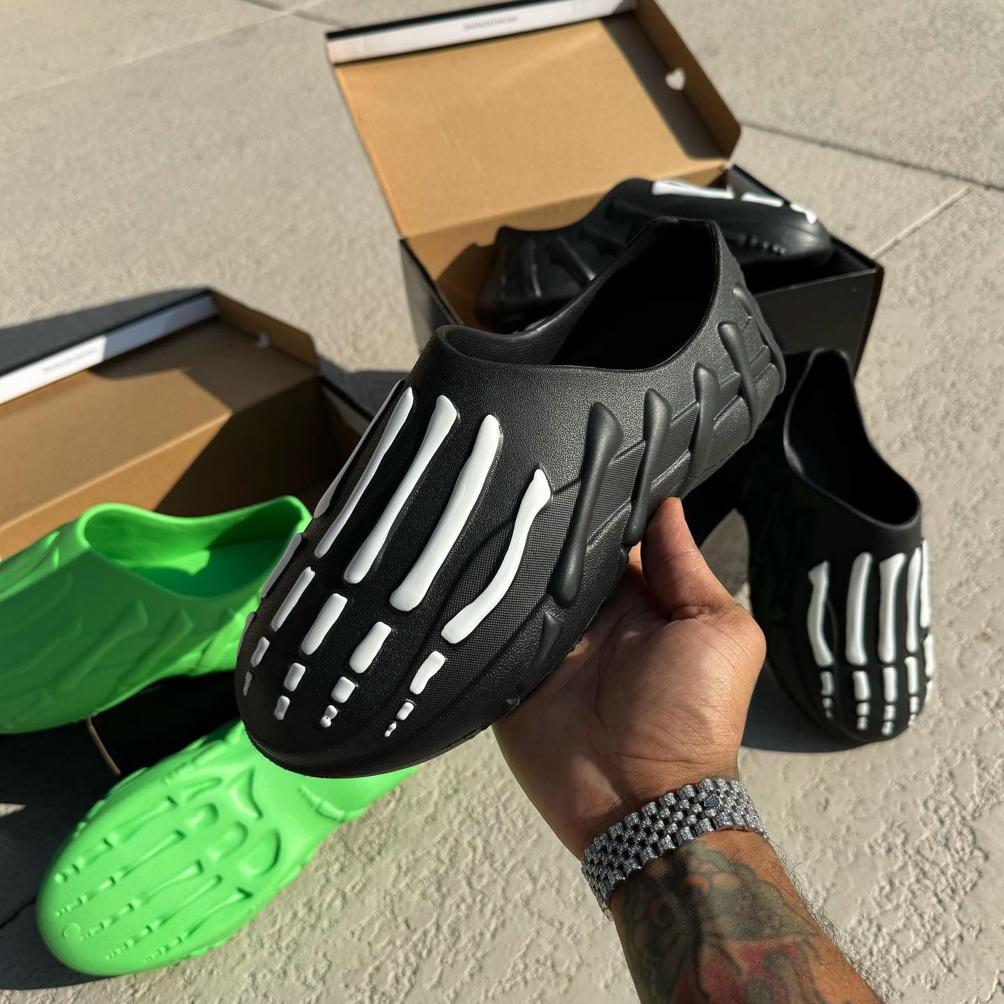 Finished Gnarcotics molded clogs with bone details in black and green, out of their boxes.
